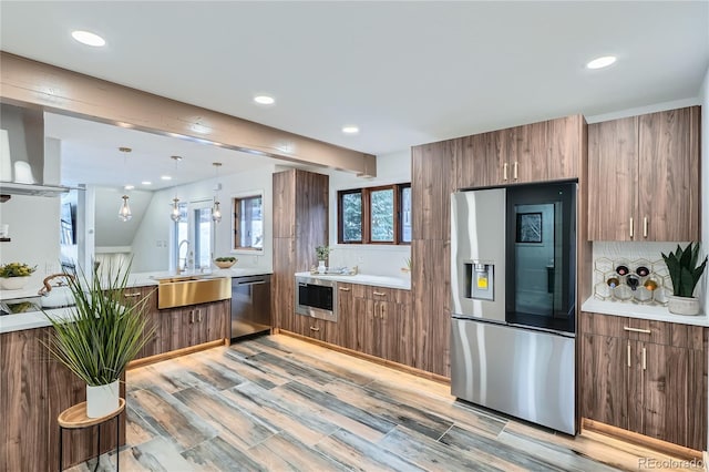 kitchen featuring light countertops, appliances with stainless steel finishes, modern cabinets, and a sink