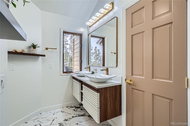 bathroom with marble finish floor, baseboards, and vanity