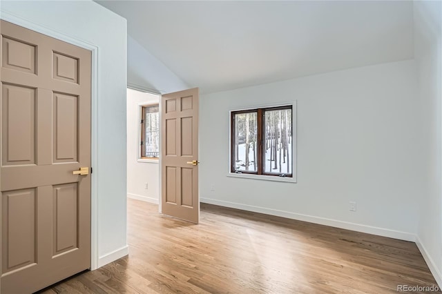 spare room featuring wood finished floors and baseboards