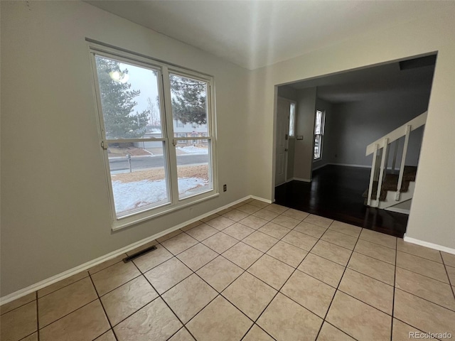 tiled empty room with plenty of natural light