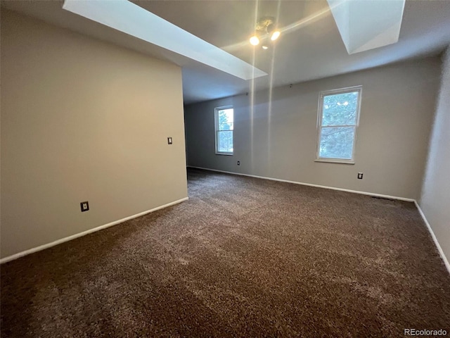 carpeted spare room with a healthy amount of sunlight