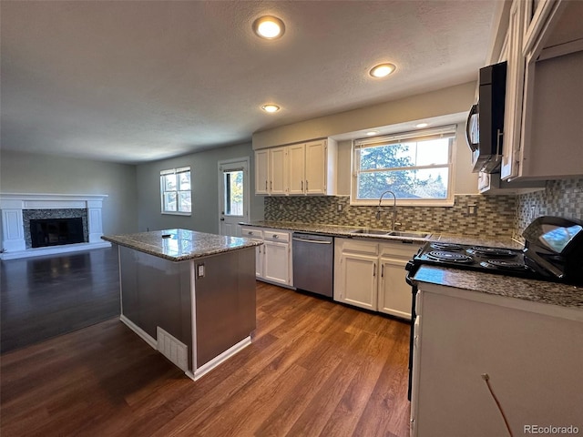 kitchen featuring dark hardwood / wood-style flooring, white cabinetry, appliances with stainless steel finishes, and sink