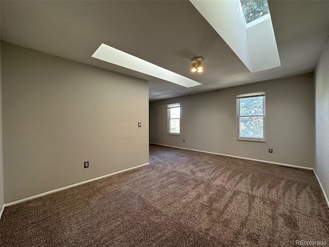 carpeted spare room with a skylight