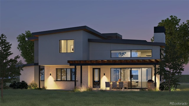 5292 Lions Paw St, Castle Rock, CO 80104 - back house at dusk featuring a lawn