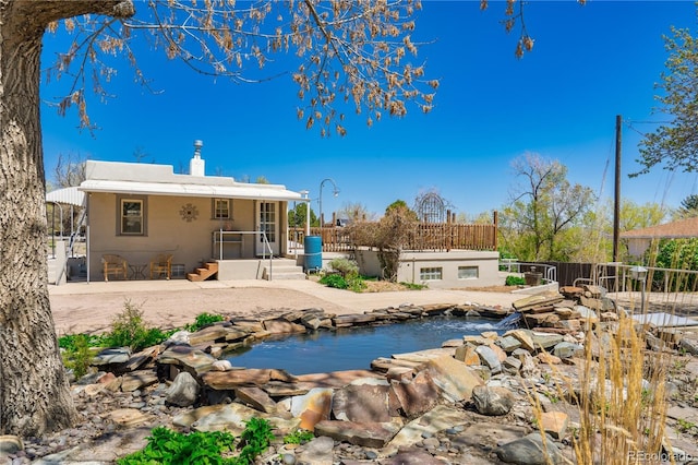 831 Manitou Blvd, Colorado Springs, CO 80904 - rear view of property with fence, a garden pond, a pool, and a chimney