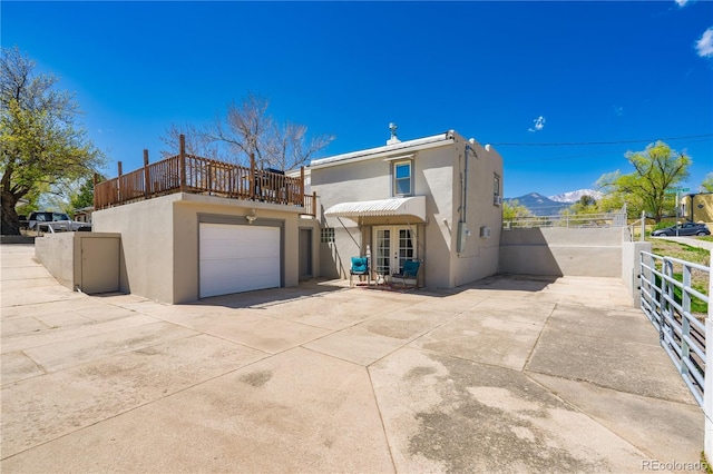 831 Manitou Blvd, Colorado Springs, CO 80904 - exterior space with a garage, a balcony, stucco siding, french doors, and driveway