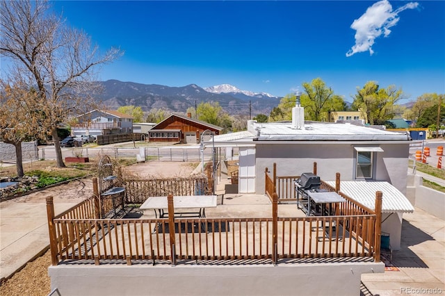 831 Manitou Blvd, Colorado Springs, CO 80904 - exterior space with stucco siding, a mountain view, a chimney, and fence
