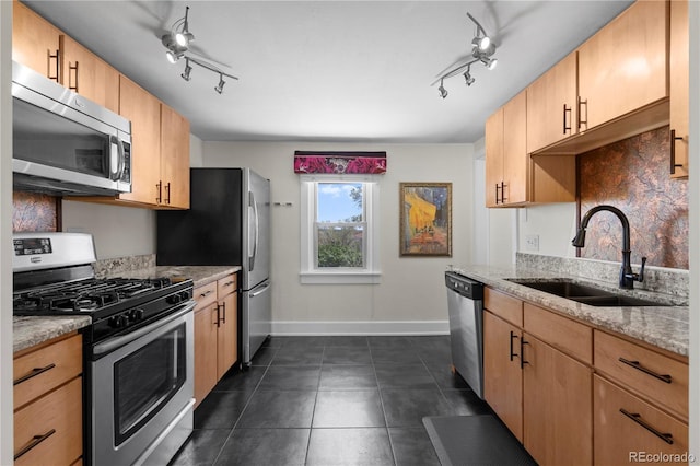 831 Manitou Blvd, Colorado Springs, CO 80904 - kitchen with track lighting, a sink, baseboards, and appliances with stainless steel finishes