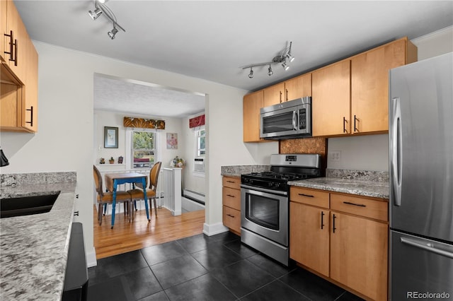 831 Manitou Blvd, Colorado Springs, CO 80904 - kitchen with appliances with stainless steel finishes, a sink, rail lighting, a baseboard radiator, and dark tile patterned flooring