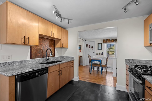 831 Manitou Blvd, Colorado Springs, CO 80904 - kitchen with baseboards, dark tile patterned floors, rail lighting, a sink, and appliances with stainless steel finishes