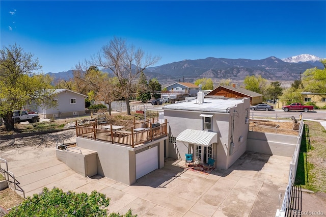 831 Manitou Blvd, Colorado Springs, CO 80904 - exterior space with a garage, a balcony, a mountain view, concrete driveway, and stucco siding
