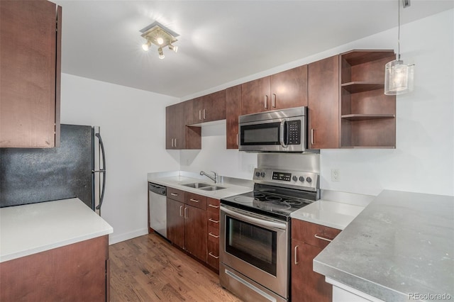 1245 Columbine St Unit 306, Denver, CO 80206 - kitchen featuring stainless steel appliances, wood finished floors, open shelves, and light countertops