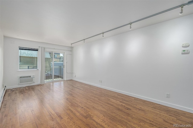 1245 Columbine St Unit 306, Denver, CO 80206 - unfurnished room with rail lighting, an AC wall unit, and wood finished floors