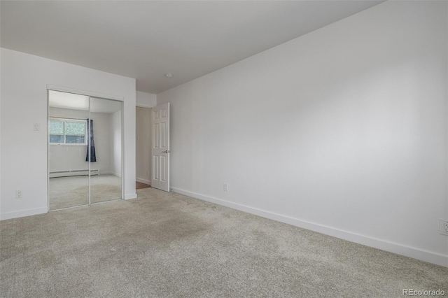 1245 Columbine St Unit 306, Denver, CO 80206 - unfurnished bedroom featuring light colored carpet, a baseboard radiator, and a closet