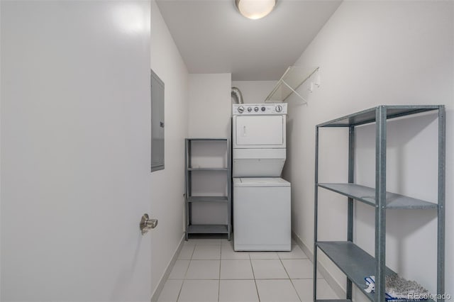 1245 Columbine St Unit 306, Denver, CO 80206 - laundry room with stacked washer / dryer, light tile patterned floors, and electric panel