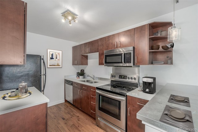 1245 Columbine St Unit 306, Denver, CO 80206 - kitchen featuring appliances with stainless steel finishes, wood finished floors, light countertops, and open shelves