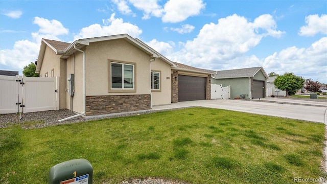 2891 Streamside Ave, Grand Junction, CO 81501 - view of front facade with a gate, stucco siding, concrete driveway, and an attached garage