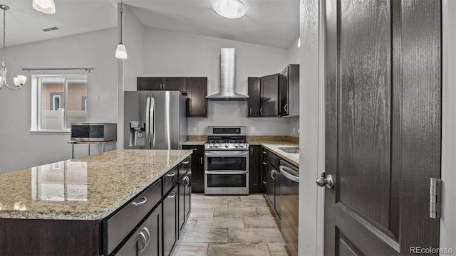 2891 Streamside Ave, Grand Junction, CO 81501 - kitchen featuring appliances with stainless steel finishes, island range hood, vaulted ceiling, a kitchen island, and pendant lighting