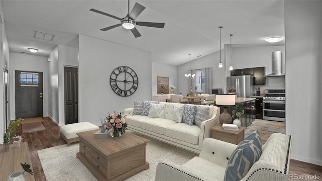 2891 Streamside Ave, Grand Junction, CO 81501 - living area featuring lofted ceiling, ceiling fan, light wood finished floors, baseboards, and a chandelier