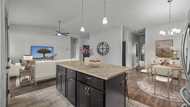 2891 Streamside Ave, Grand Junction, CO 81501 - kitchen with open floor plan, dark cabinets, pendant lighting, ceiling fan, and vaulted ceiling