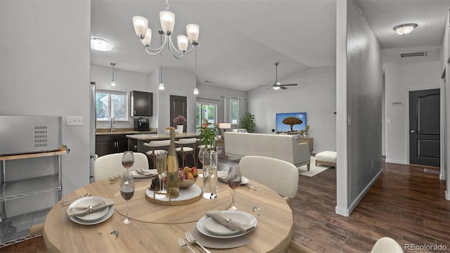 2891 Streamside Ave, Grand Junction, CO 81501 - dining room with dark wood-style floors, a ceiling fan, vaulted ceiling, baseboards, and a chandelier