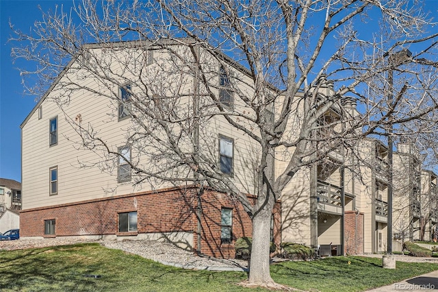 499 Wright St Unit 308, Lakewood, CO 80228 - view of property exterior featuring brick siding and a lawn