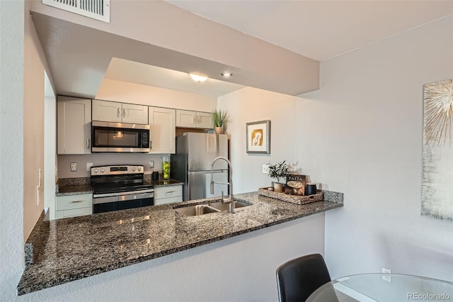 499 Wright St Unit 308, Lakewood, CO 80228 - kitchen with a sink, visible vents, dark stone countertops, and stainless steel appliances