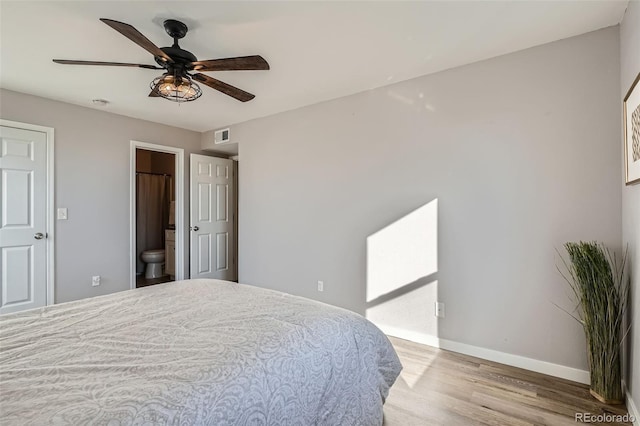 499 Wright St Unit 308, Lakewood, CO 80228 - bedroom with connected bathroom, a ceiling fan, visible vents, wood finished floors, and baseboards