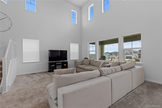 8550 Cheraw St, Littleton, CO 80125 - carpeted living room featuring a towering ceiling and plenty of natural light