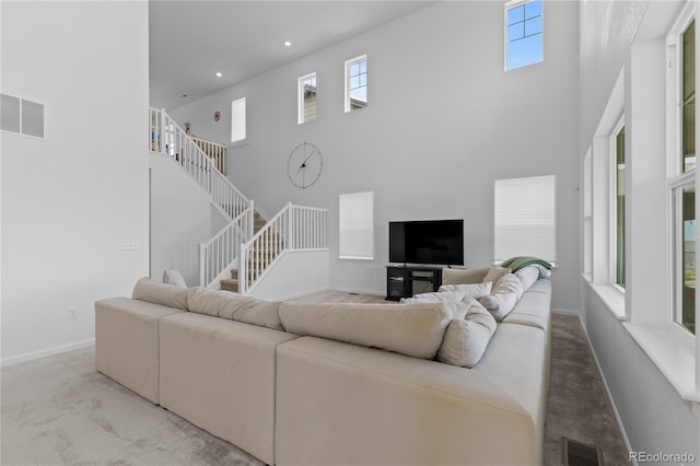 8550 Cheraw St, Littleton, CO 80125 - carpeted living room with a high ceiling, plenty of natural light, stairway, and recessed lighting
