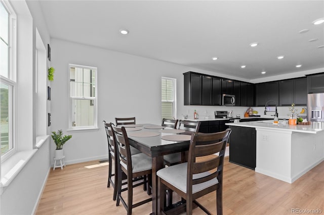 8550 Cheraw St, Littleton, CO 80125 - dining space with light wood-style flooring, healthy amount of natural light, and recessed lighting