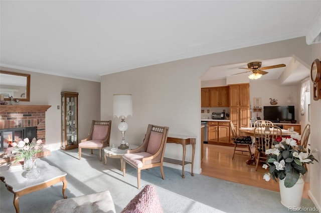 living room with a ceiling fan, arched walkways, a fireplace, crown molding, and light colored carpet