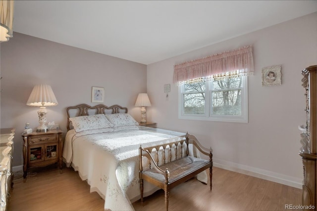 bedroom featuring baseboards and light wood-style flooring