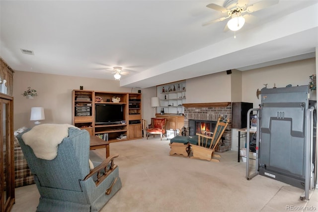 carpeted living area with visible vents, a brick fireplace, and a ceiling fan