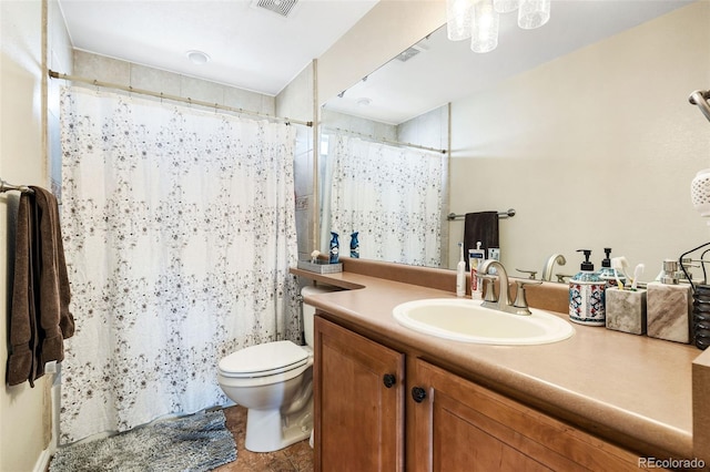 bathroom featuring toilet and vanity