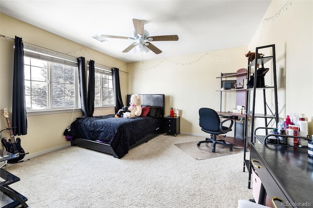 bedroom featuring ceiling fan and carpet