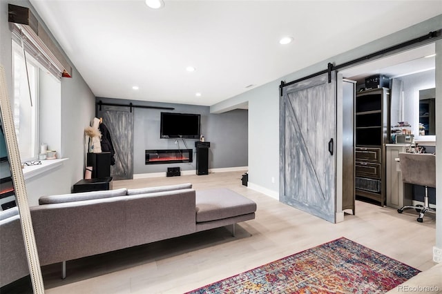 living room featuring light wood-type flooring and a barn door