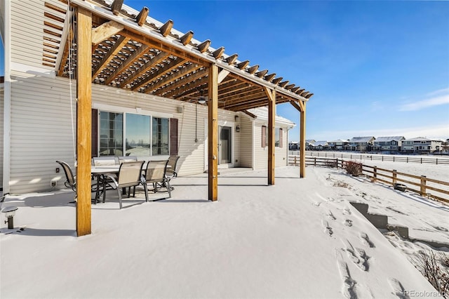 snow covered patio featuring a pergola