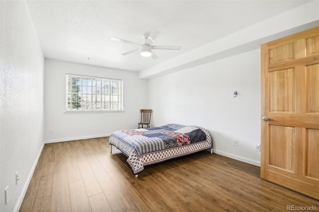 bedroom featuring ceiling fan and dark wood-type flooring