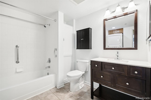 full bathroom featuring vanity, stacked washer and dryer, tile patterned flooring, toilet, and tub / shower combination