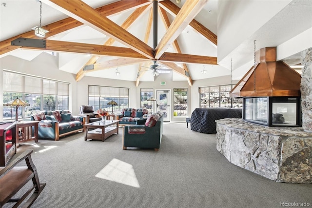 living room with ceiling fan, carpet floors, a fireplace, and high vaulted ceiling