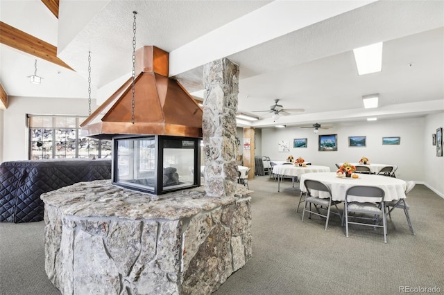 kitchen with ceiling fan, carpet floors, and a textured ceiling