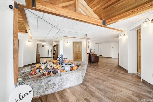 living room featuring lofted ceiling and hardwood / wood-style flooring