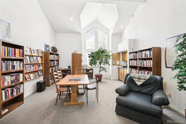 carpeted home office featuring high vaulted ceiling