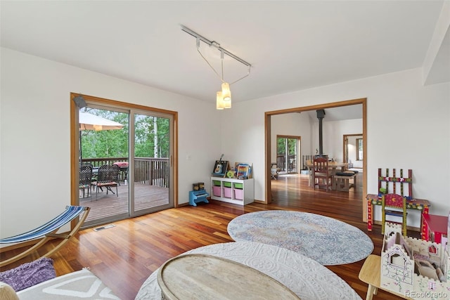 100 Moon Gulch Rd, Rollinsville, CO 80422 - living room with healthy amount of natural light, wood finished floors, and rail lighting