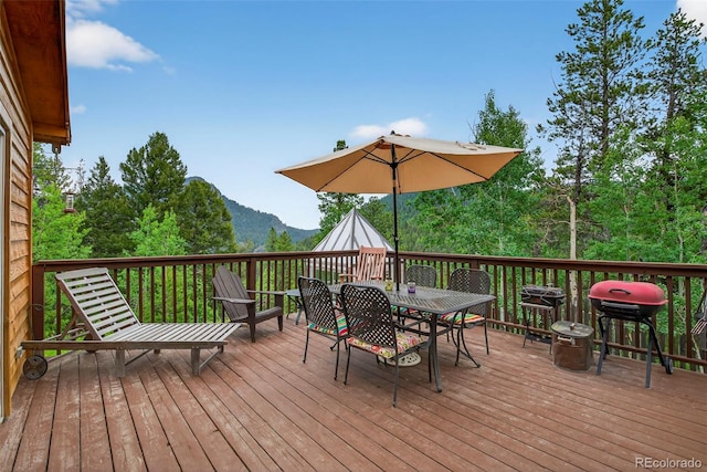 100 Moon Gulch Rd, Rollinsville, CO 80422 - wooden terrace featuring outdoor dining area, a mountain view, and a grill
