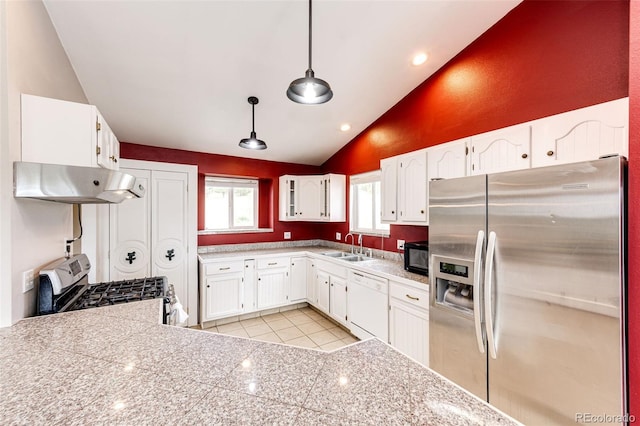 kitchen with appliances with stainless steel finishes, under cabinet range hood, a sink, light tile patterned floors, and white cabinetry