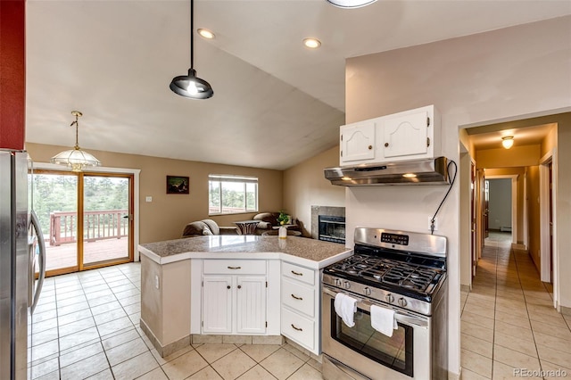 kitchen featuring stainless steel appliances, under cabinet range hood, tile countertops, light tile patterned flooring, and vaulted ceiling