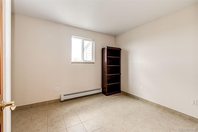 spare room with a baseboard radiator, baseboards, and light tile patterned floors