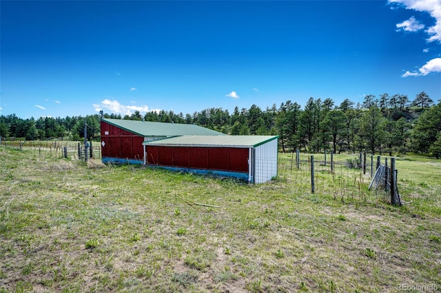 view of yard with an outbuilding, an outdoor structure, and a view of rural / pastoral area